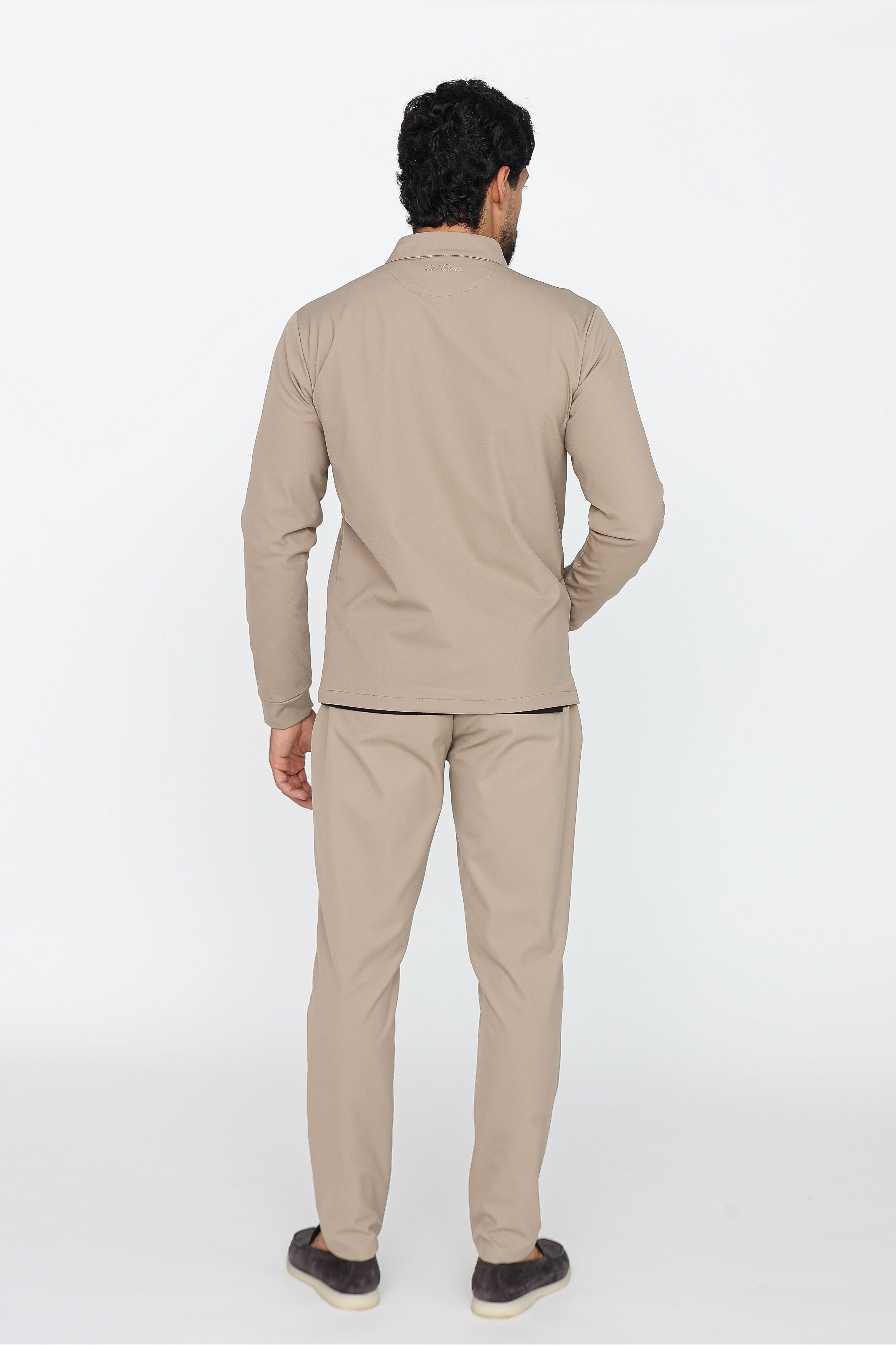 Man wearing a beige outfit on a white background