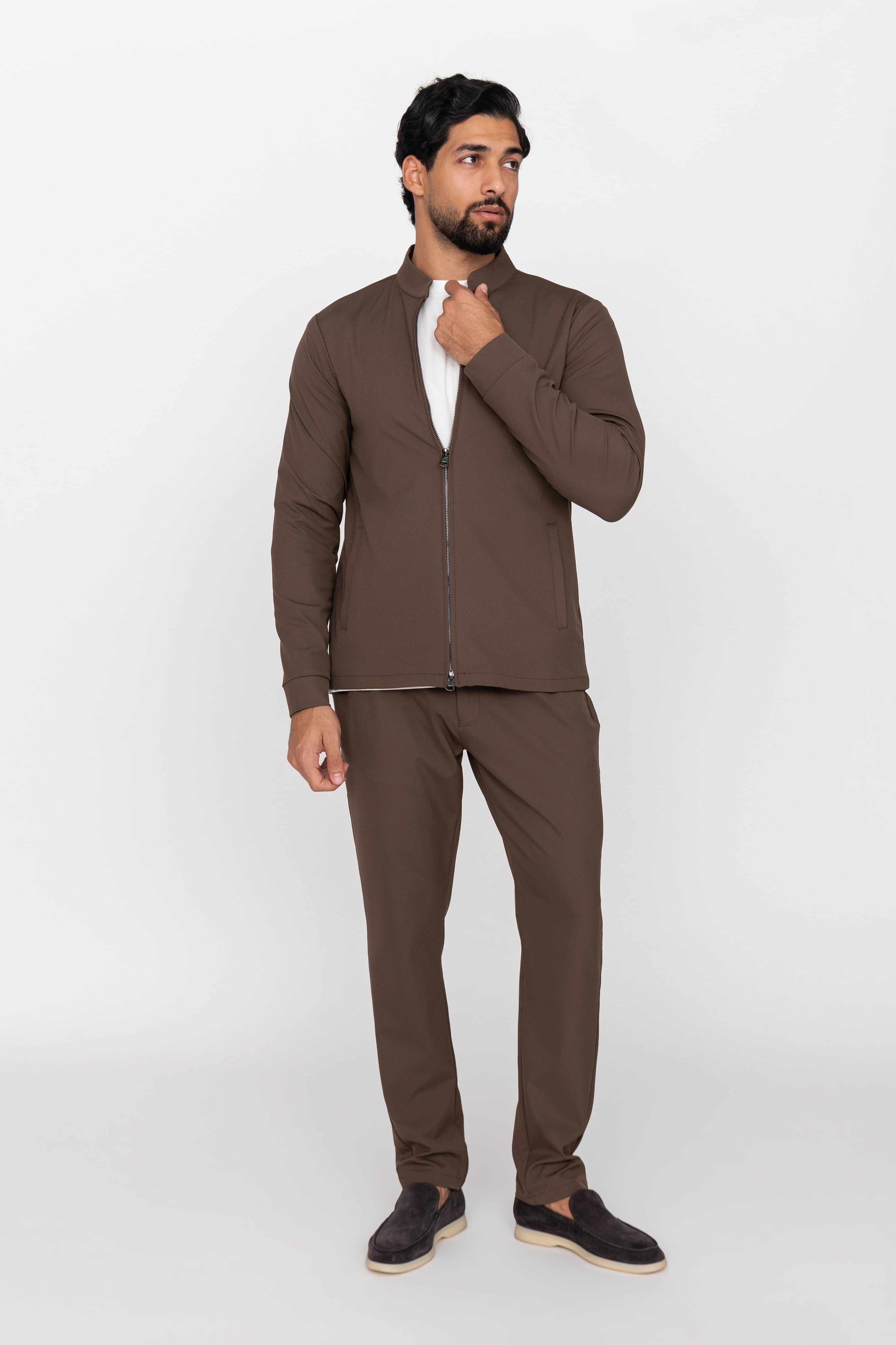 Man wearing a brown outfit on a white background