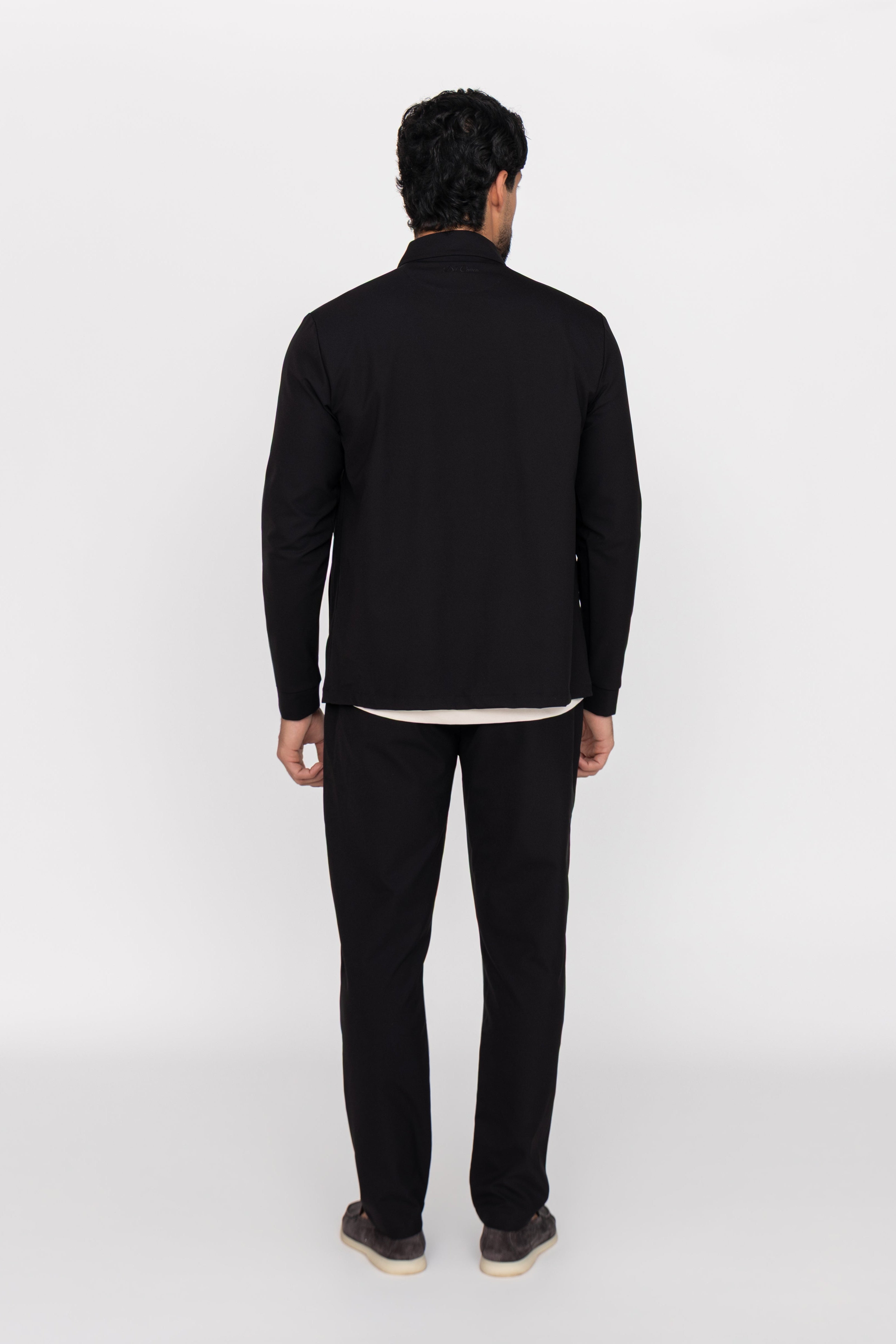 Person wearing a black outfit on a white background